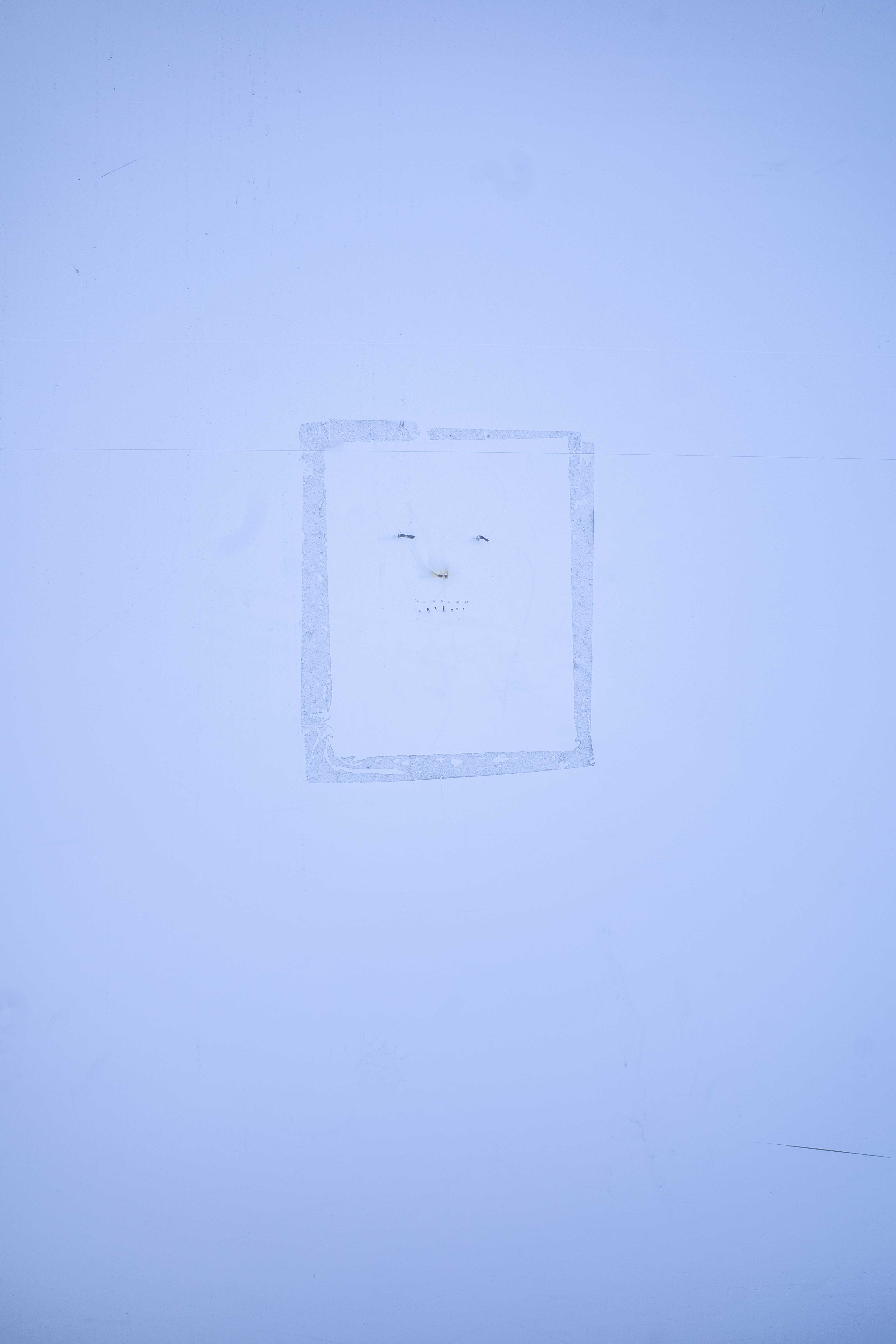 Carita dibujada sobre pared blanca